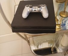 Playstation 4 slim with controller.