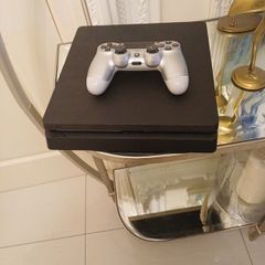 Playstation 4 slim with controller.