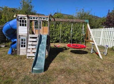 Garden Playhouse with 2 slides and 2 swings and monkey bar