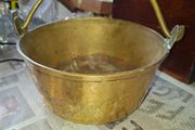 Antique Brass Cauldron Jam Pan features a Polished Brass finish with a Swing Handle secured by riveted joints, Historically used as a "jam pan" for making preserves over an open fire or stove-top. Material: Constructed from solid brass