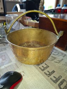 Antique Brass Cauldron Jam Pan features a Polished Brass finish with a Swing Handle secured by riveted joints, Historically used as a "jam pan" for making preserves over an open fire or stove-top. Material: Constructed from solid brass