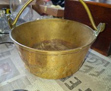 Antique Brass Cauldron Jam Pan features a Polished Brass finish with a Swing Handle secured by riveted joints, Historically used as a "jam pan" for making preserves over an open fire or stove-top. Material: Constructed from solid brass