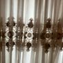 5 decorative pillows with a large beautiful laces curtain in brown and white colors Image 4