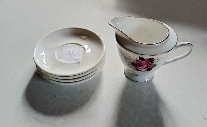 Milk Jug & 4 Saucers (used).