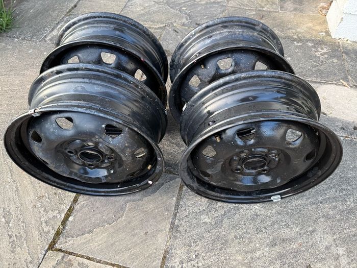 Four Black Steel Wheel Rims and Sixteen bolts