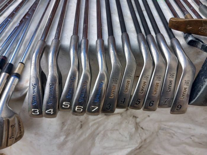 A selection of Golf clubs. Bags and golf balls.