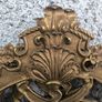 large, ornate gold mirror features a baroque frame Image 8