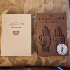 The Logogryph. By Thomas Wharton. First Edition Complete With Presentation Sleeve Paperback In Very Good Condition. 37