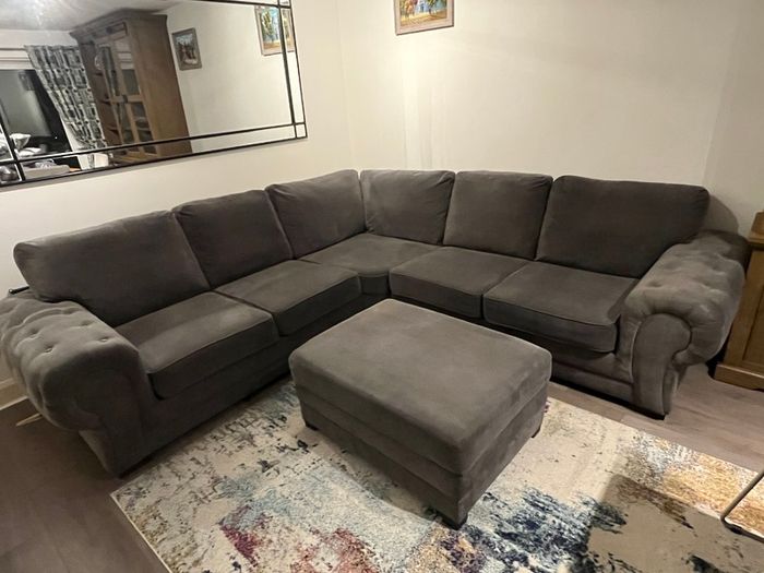 Grey corner sofa with matching footstool