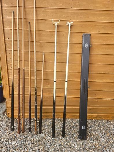 Pool cues, bridge, rest and case.