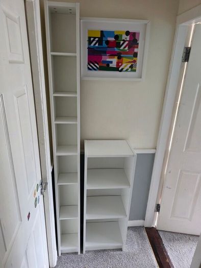 Two white shelving units (bookcase, display, other storage)