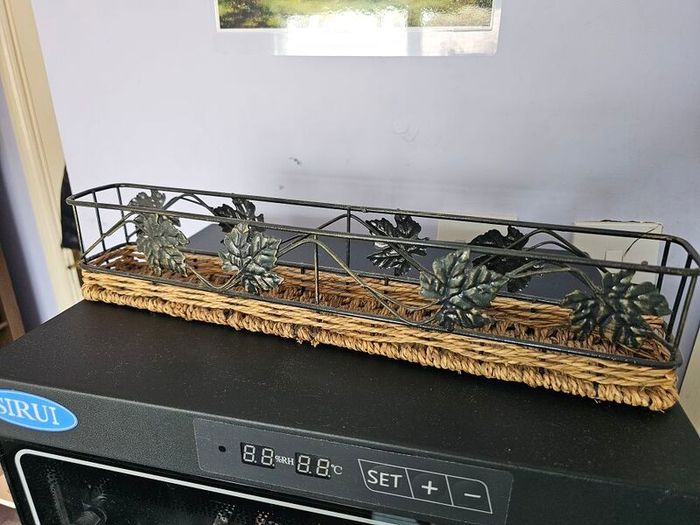 Decorative metal and wicker tray in good condition.