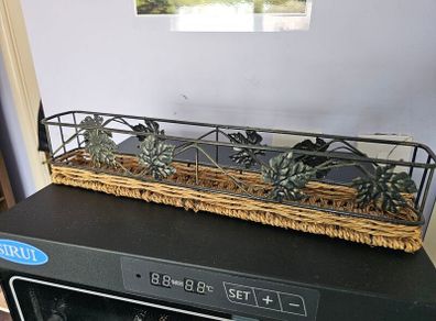 Decorative metal and wicker tray in good condition.