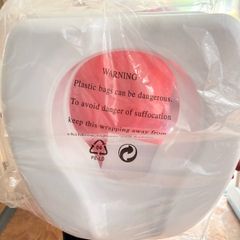 Toilet seat raiser. New. In packaging.