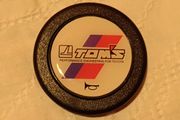 Genuine vintage TOM'S horn button for Toyota steering components.