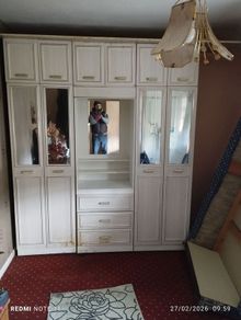 Double bedroom wardrobe with drawers and mirror in-between wardrobes and plenty of storage above