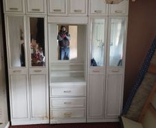 Double bedroom wardrobe with drawers and mirror in-between wardrobes and plenty of storage above