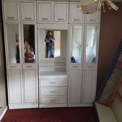 Double bedroom wardrobe with drawers and mirror in-between wardrobes and plenty of storage above