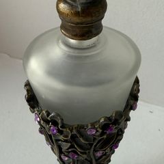 Vintage-style frosted glass perfume bottle.