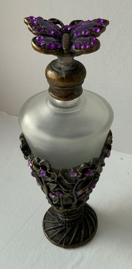 Vintage-style frosted glass perfume bottle.