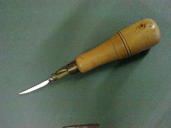 Old boxwood and brass tool pad with tools