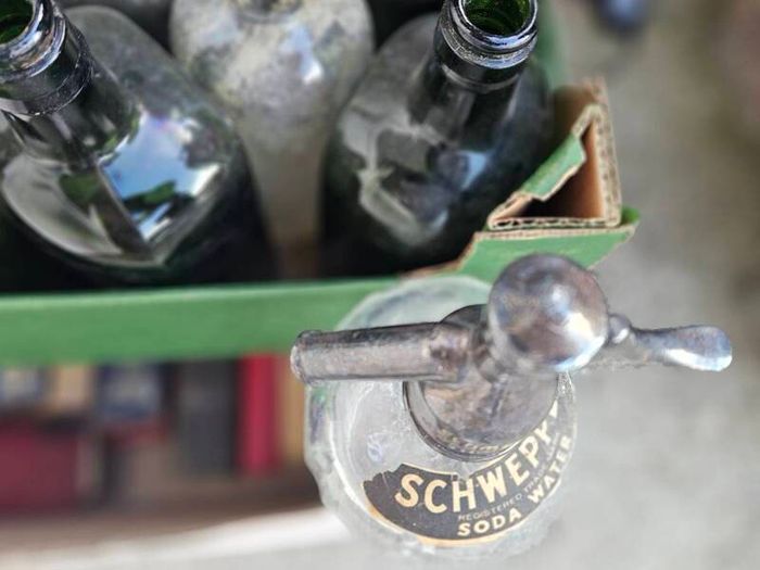 Box of Vintage Bottles and Schweppes Soda Syphon