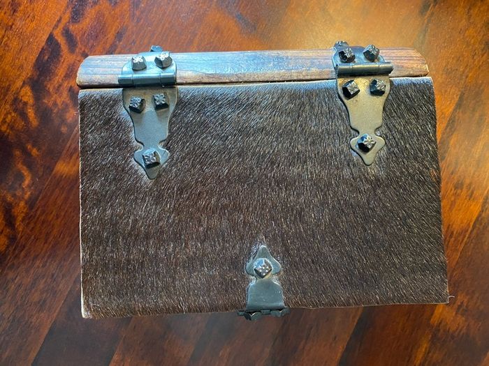 antique A wooden box in the form of a book, having brass escutcheon and black metal hinges. 18 x 15cm.