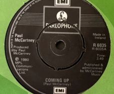 Paul McCartney - Coming Up. Irish seven inch single from 1980 with green EMI Irish cover. Die Cut Centre version. Mint.