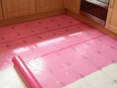 Self-adhesive film, quickly and simply applied to most hard surfaces such as worktops and kitchen units and protects against scratches, dirt, dust, spills and splashes.