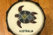 This is a small hand-carved Australian drum with a hand-painted turtle design