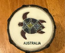 This is a small hand-carved Australian drum with a hand-painted turtle design