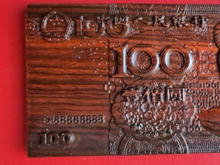 Carved wooden banknote. 100 yuan.