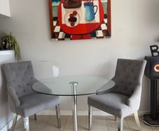 Glass table with velvet studded chairs