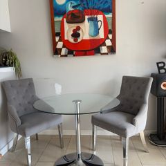 Glass table with velvet studded chairs