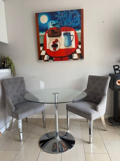 Glass table with velvet studded chairs