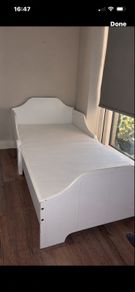 white wooden toddler bed