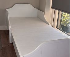 white wooden toddler bed