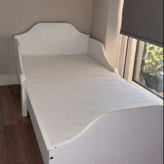 white wooden toddler bed