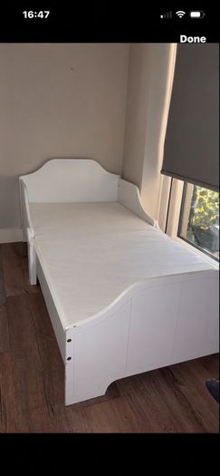 white wooden toddler bed