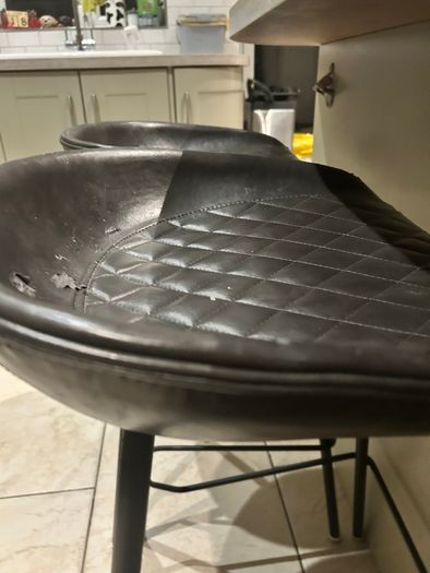 Three  black quilted kitchen bar stools