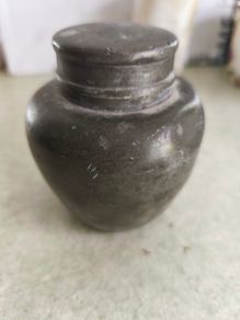 Chainse  tin tea caddy. It is an antique item, possibly from the late 19th or early 20th century.