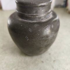 Chainse  tin tea caddy. It is an antique item, possibly from the late 19th or early 20th century.