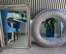 two silver framed mirrors