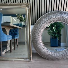two silver framed mirrors