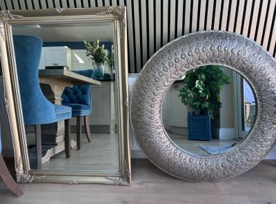 two silver framed mirrors