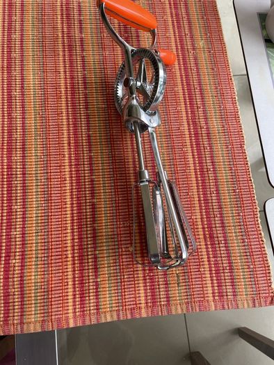 Vintage whisk , steel with orange bakelite handle