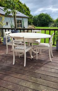 Antique Oval drop leaf table with claw legs and four chairs