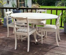 Antique Oval drop leaf table with claw legs and four chairs