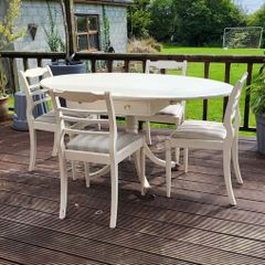 Antique Oval drop leaf table with claw legs and four chairs