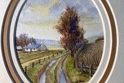 picture Country lane landscape featuring a whitewashed cottage, bare trees, and rutted track.